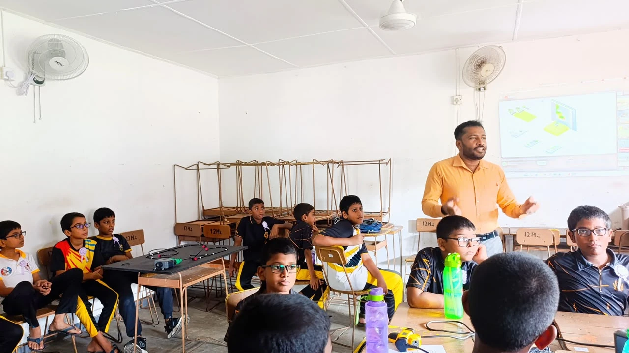 NEST members working alongside students in the school classroom