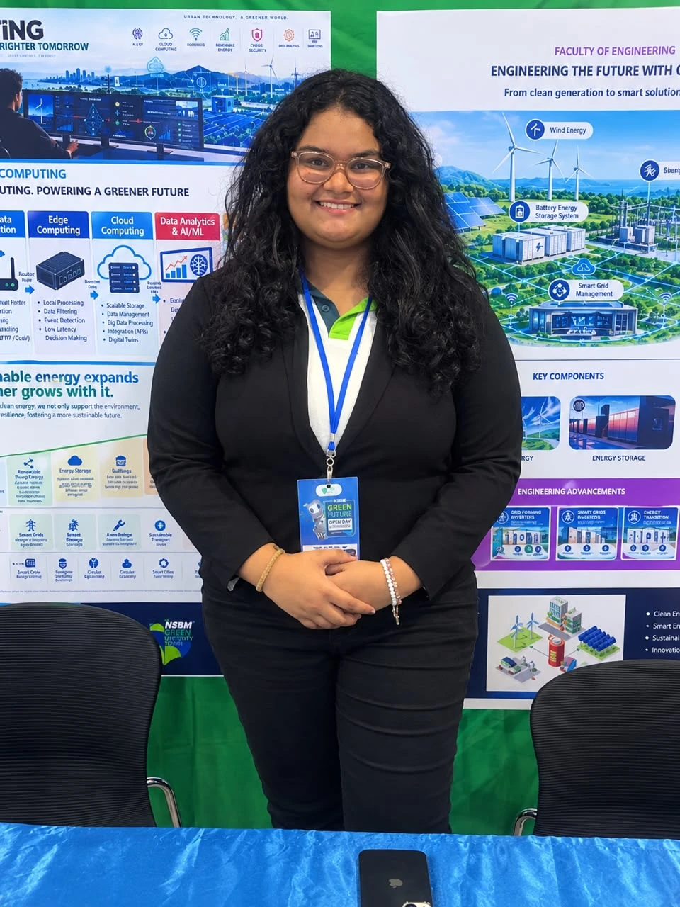 A club member in a black blazer standing in front of the Open Day billboards